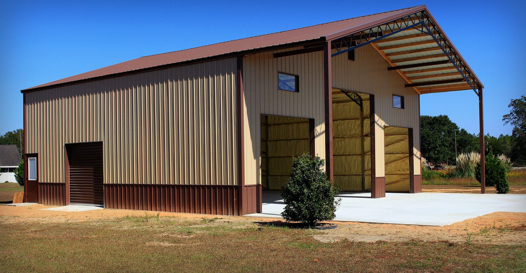 TAN METAL ENCLOSED POLE BARN WITH BROWN TRIM AND PORCH BUILT BY BLACKWATER TRUSS SYSTEMS